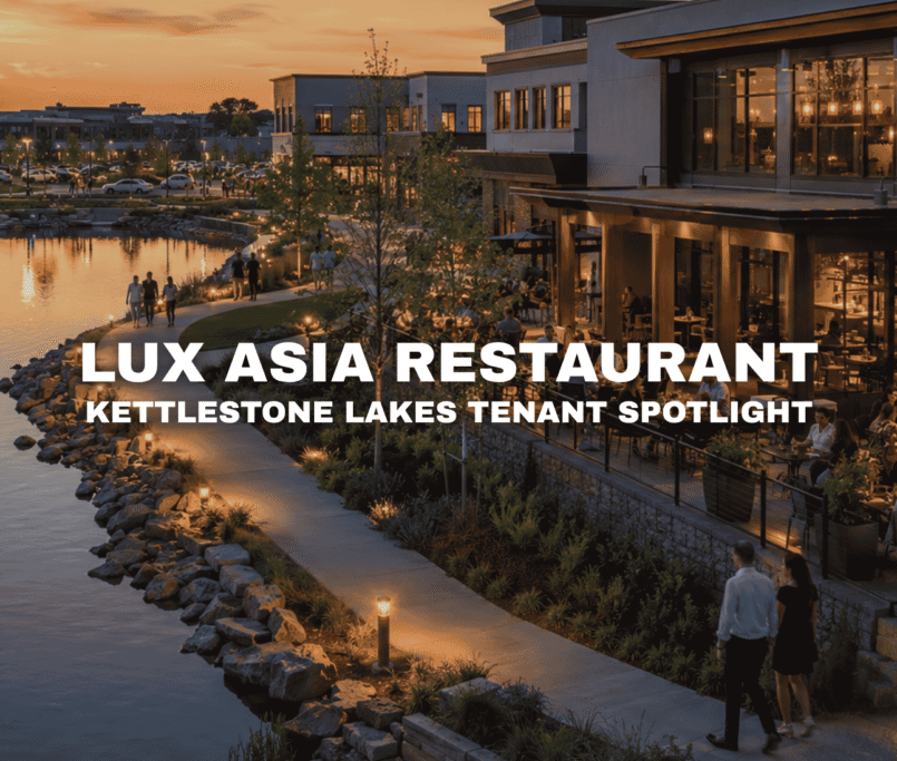 Lakeside restaurant and bar patio at Kettlestone Lakes in Waukee, Iowa, with outdoor dining, evening lighting, walking paths, and modern mixed-use storefronts.